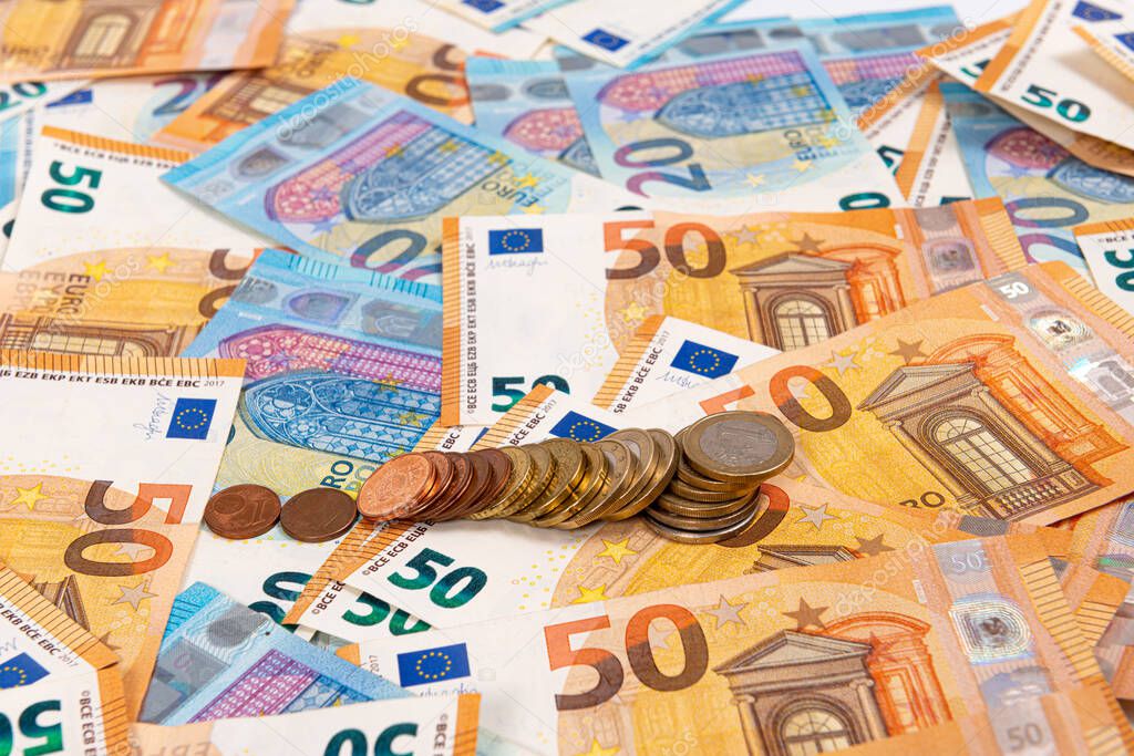 coins on the background of euro banknotes, Euro bill as part of the economic and trading system, Close-up