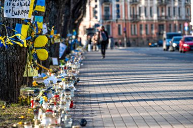 Riga, Letonya, 18 Mart 2022: Riga, Letonya 'daki Ukrayna Büyükelçiliği önünde Ukrayna' yı destekleyen çiçekler, mumlar ve posterler