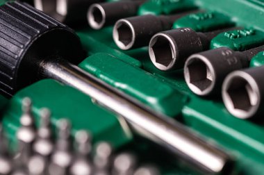 Interchangeable screwdriver set with different types of metal steel heads and bits, selective focus