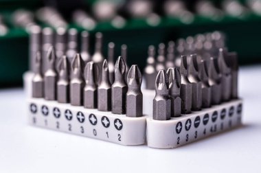 Interchangeable screwdriver bit set, isolated on white, selective focus,  dof, close-up