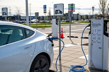 Riga, Latvia, April 29, 2022: electric car Tesla Model S Dual Motor at the charging station in the supermarket public parking