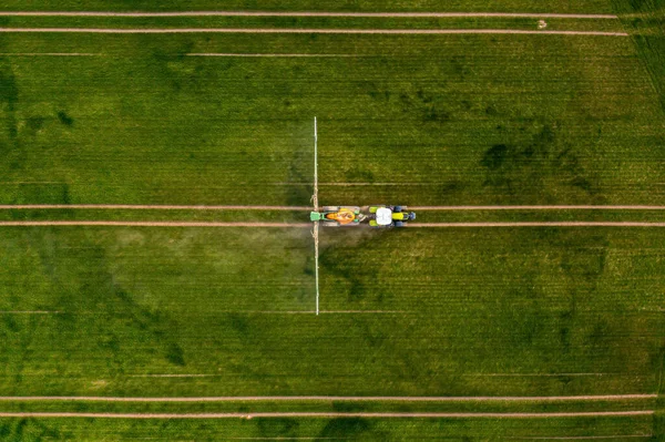 Top View Tractor Spraying Chemicals Large Green Field Agriculture Concept — Foto de Stock