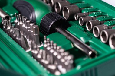 Interchangeable screwdriver set with different types of metal steel heads and bits, selective focus