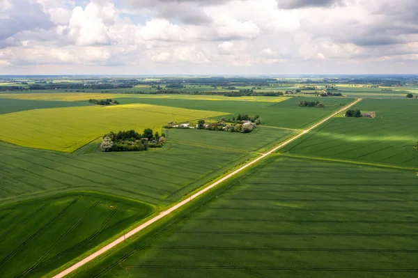 rural landscape before the storm, view from above on agricultural fields, roads and storm clouds