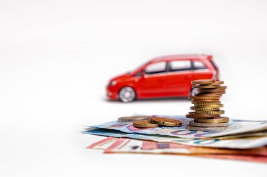 red car, euro banknotes and coins isolated on white background with clipping path, insurance concept