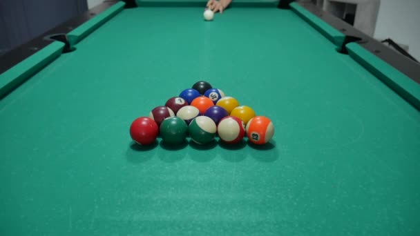 色と番号のついたビリヤードのゲーム 8ボール 緑のテーブルとビリヤードキューでボールを動かす 白いボールをパンニングして — ストック動画