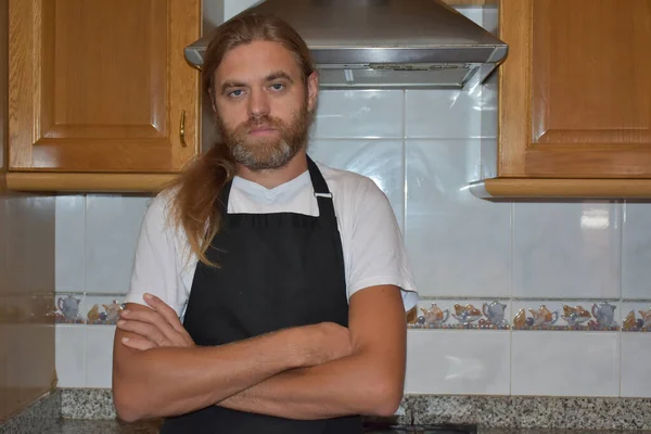 portrait of a young man in a kitchen