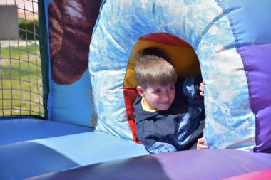 Çocuklar şişme kalede oynuyorlar.,