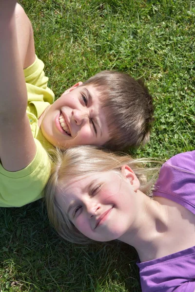 Cute Kids Laying Green Grass Enjoying Sun —  Fotos de Stock