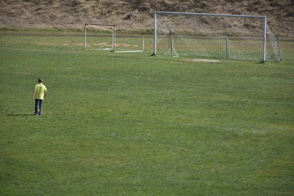 Young Boy Playing Football Green Field — Zdjęcie stockowe
