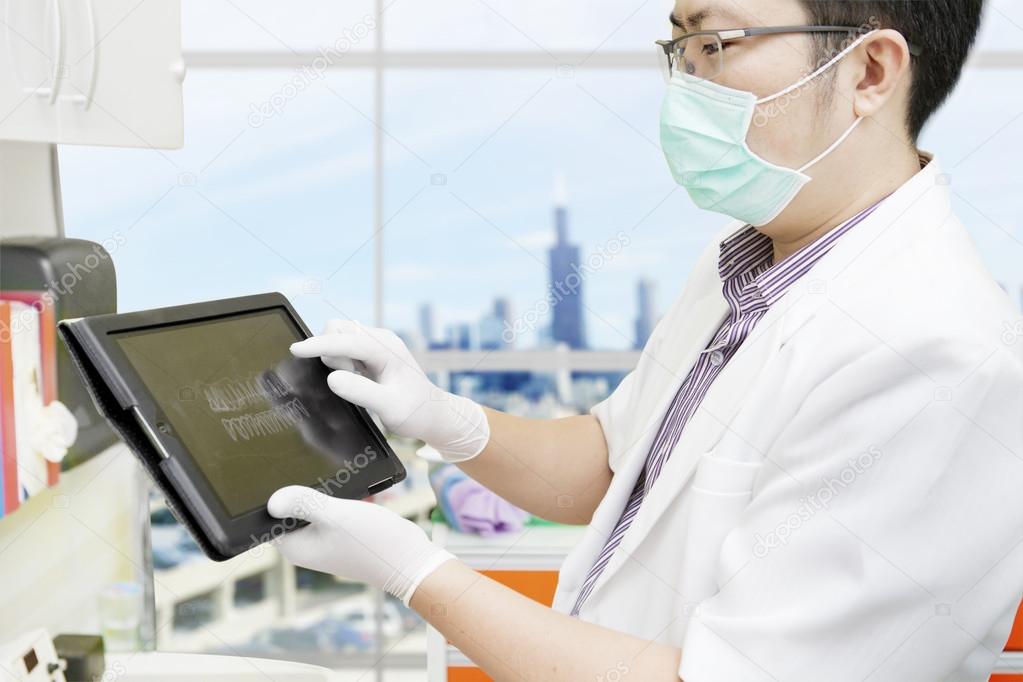 Dentist with computer tablet