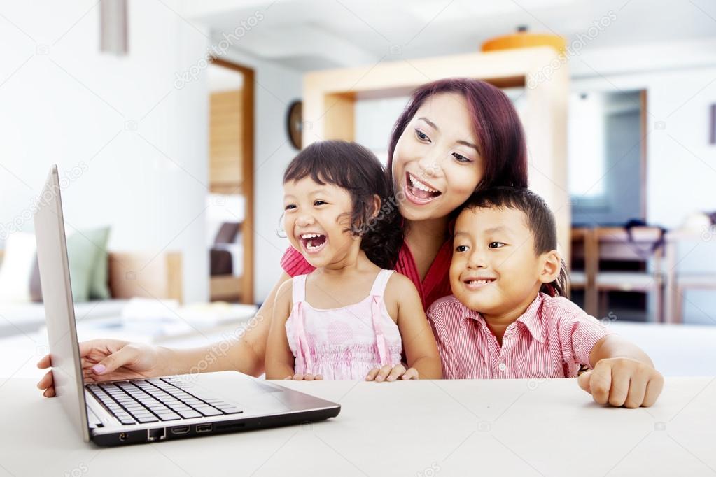 Happy family with laptop at home 1