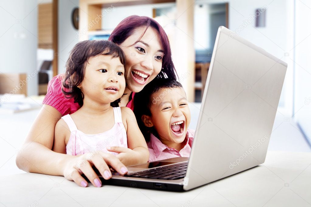 Happy family with laptop at home