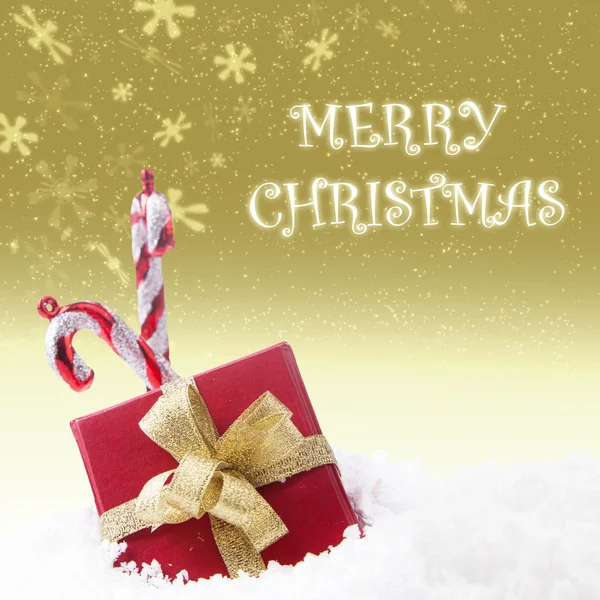 De gift van Kerstmis met twee snoep stokken op gouden lichten achtergrond — Stockfoto