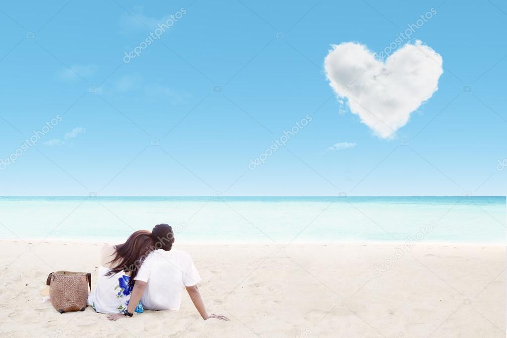 Enjoying honeymoon at white sand beach with love cloud