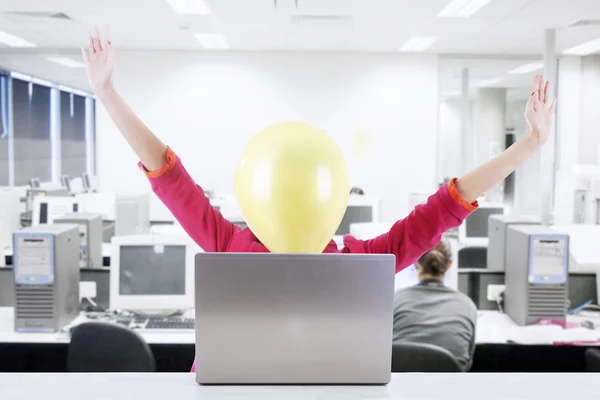 Happy businesswoman with balloon