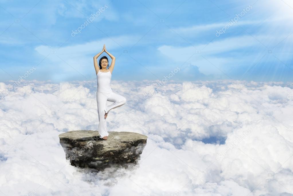 Beautiful yoga above clouds