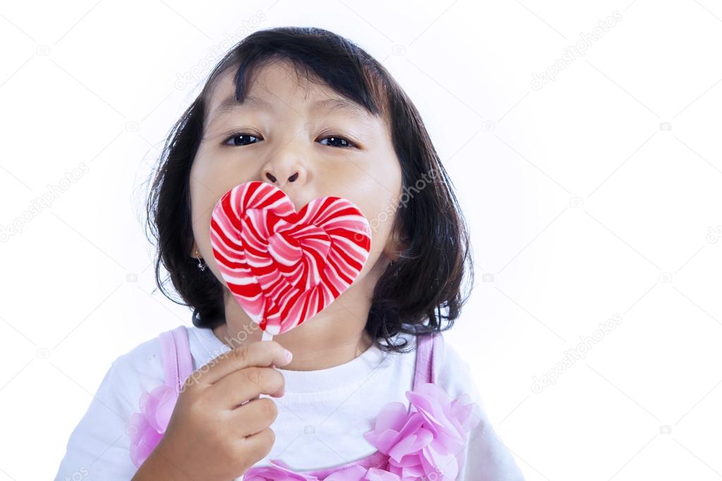 Girl licking lollipop