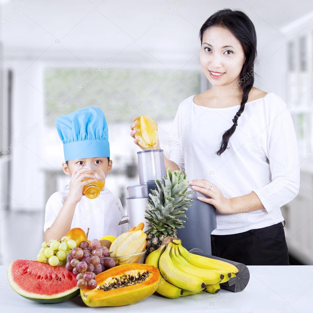 Healthy family having fruit juice at home