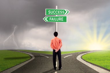 Businessman choosing success or failure road