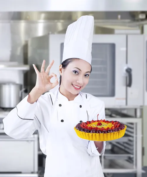 Chef holding delicious cake at work Royalty Free Stock Images