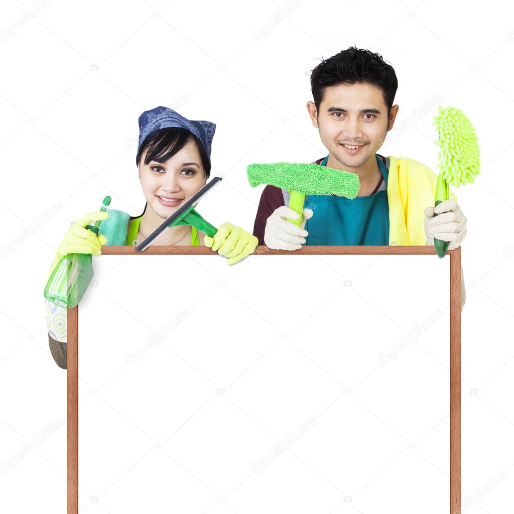 Cleaning service couple holding copyspace