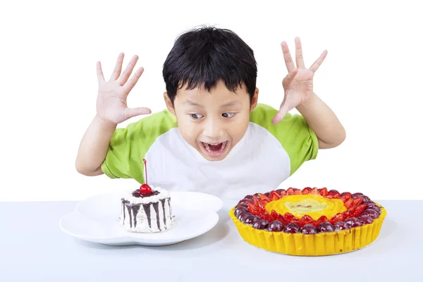 Opgewonden jongen eten dessert geïsoleerd op wit — Stockfoto