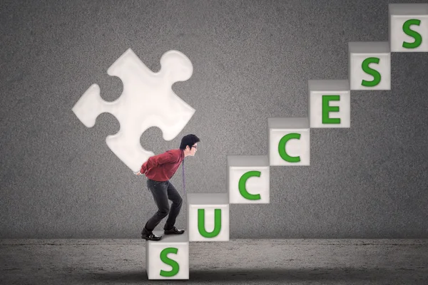 Businessman carry puzzle piece of success — Stock Photo, Image