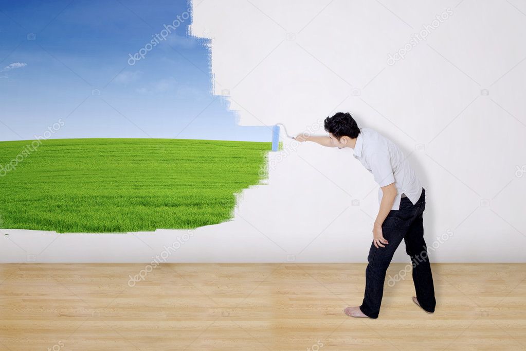 Boyfriend painting green field on wall