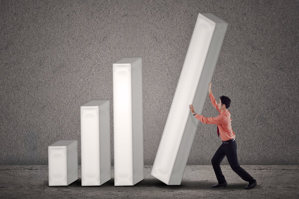 Asian businessman pushing a bar chart