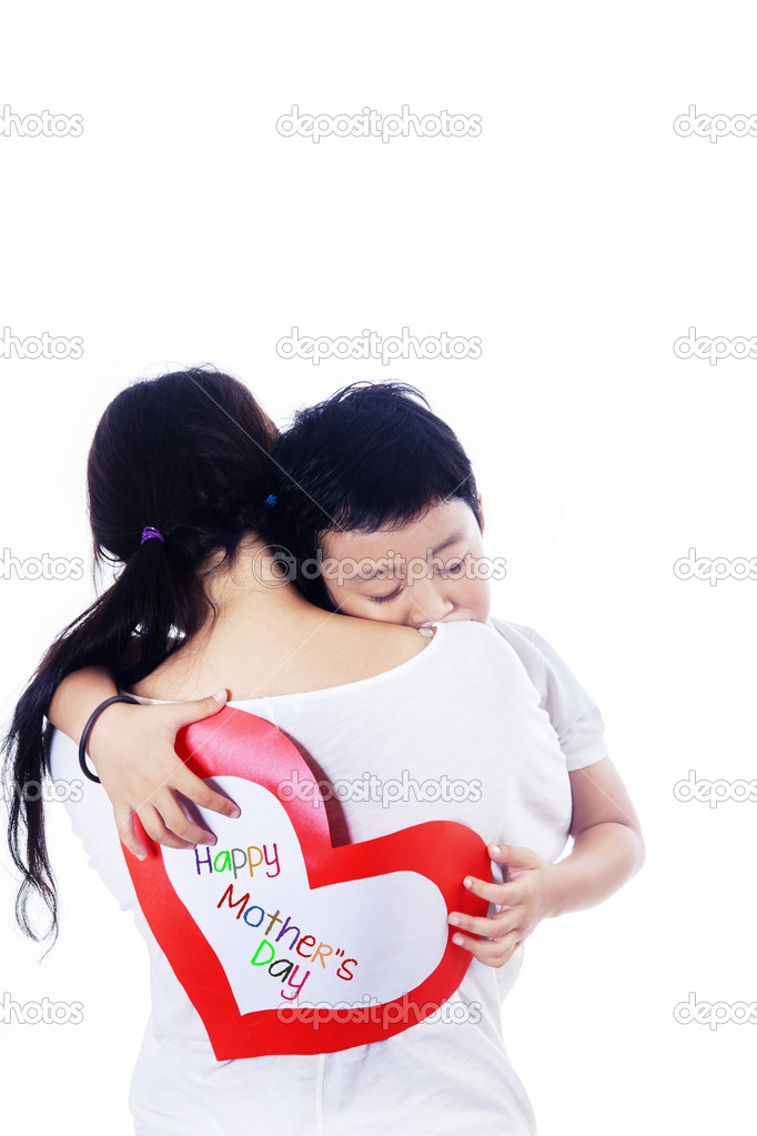Boy hug mother holding love card on white