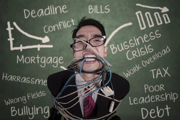 Close-up crazy businessman tied in cable and rope at class — Stock Photo, Image