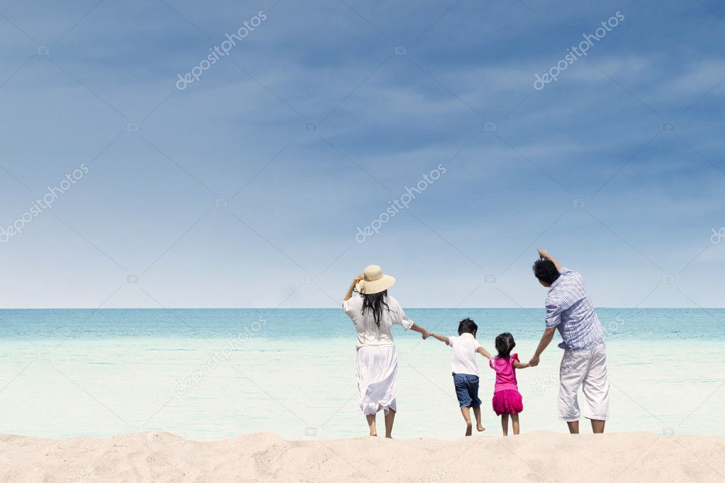 Happy family at white sand beach, Australia
