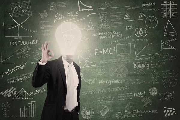 Smart teacher with lightbulb head in class — Stock Photo, Image