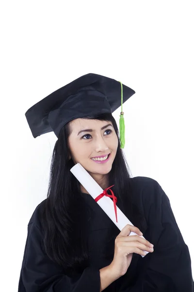 Beautiful woman in black graduation gown - isolated — Stock Photo, Image