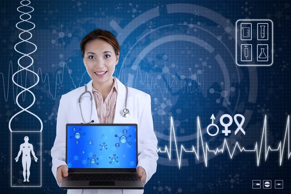 Beautiful scientist hold laptop on blue background — Stock Photo, Image