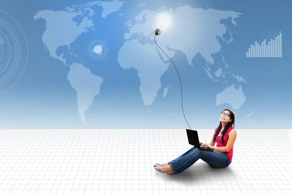 Asian female using laptop on world map — Stock Photo, Image