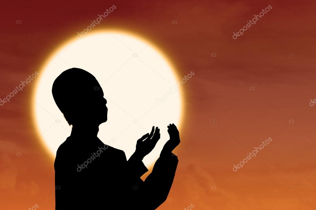 Silhouette of muslim praying at sunset