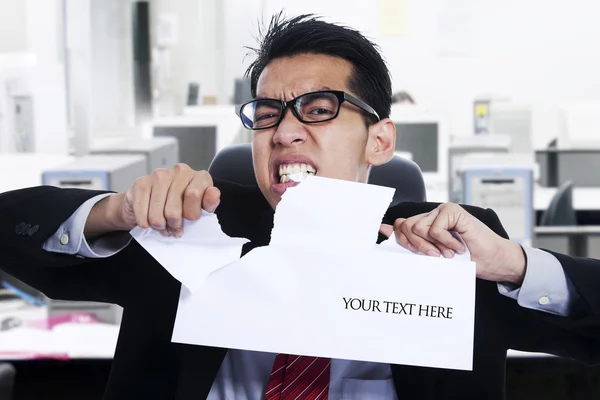 Angry businessman tear paper at office — Stock Photo, Image