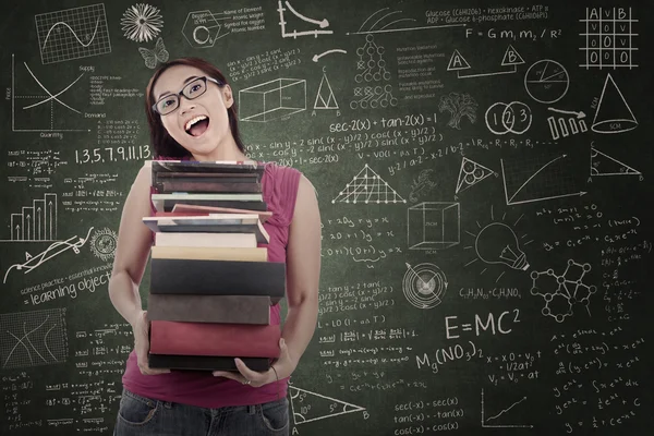 Happy female student bring books at class — Stock Photo, Image