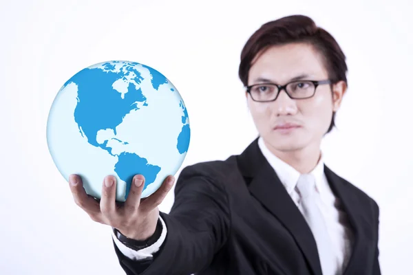 Businessman giving world globe on white — Stock Photo, Image