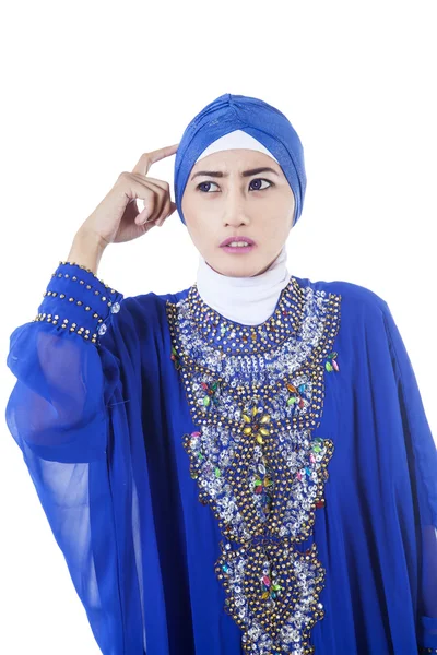 Confused female muslim in blue dress - isolated — Stock Photo, Image