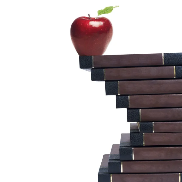 Manzana y libros aislados en blanco — Foto de Stock