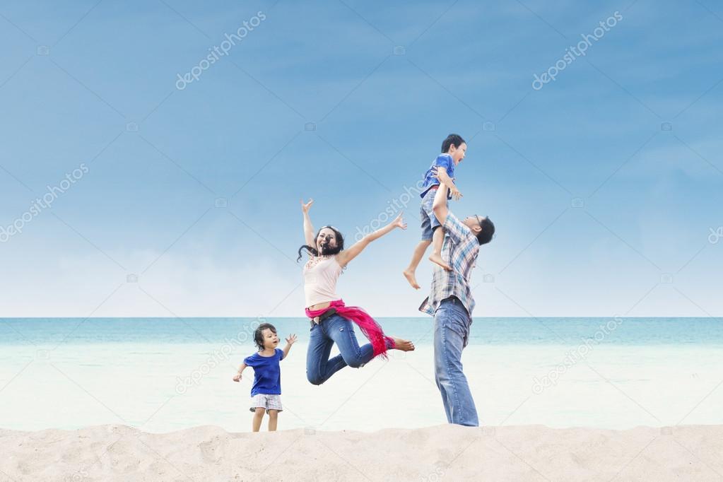 Asian family enjoy time at beach