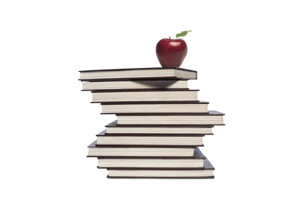 Apple and pile of books on white background — Stock Photo, Image