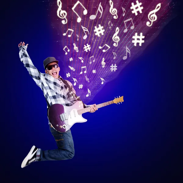 Guitarist jumping with musical notes on blue — Stock Photo, Image