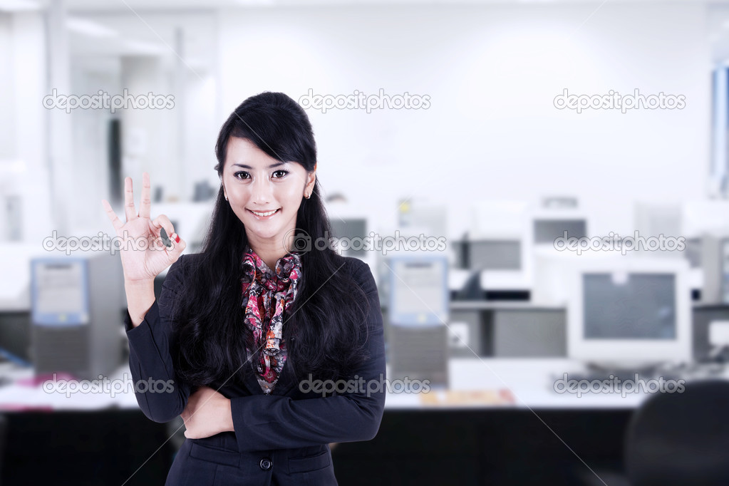 Businesswoman approval gesture at office