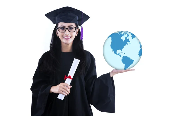 Beautiful female graduate holding world globe - isolated — Stock Photo, Image