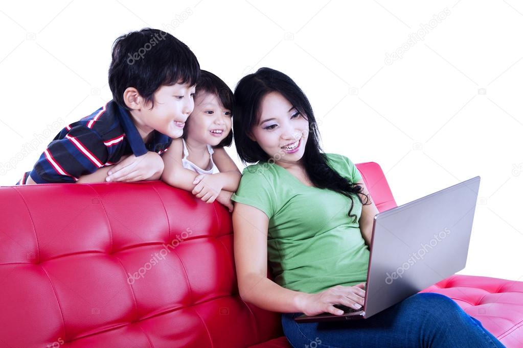 Asian mum and her kids browsing the internet