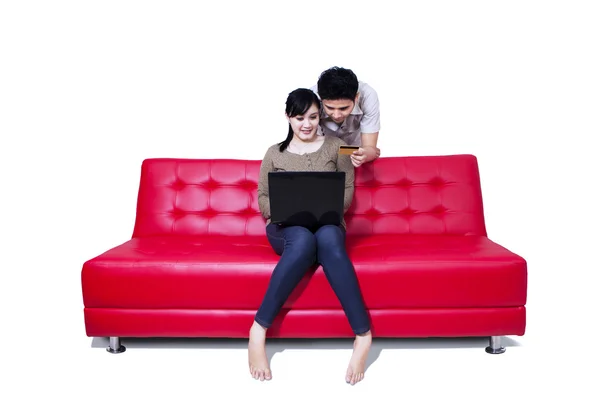Asian couple pay online shopping by credit card - isolated — Stock Photo, Image